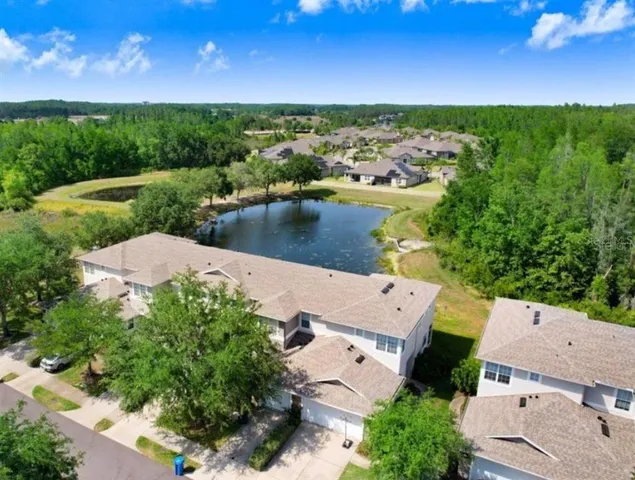 an aerial view of a house with a lake view