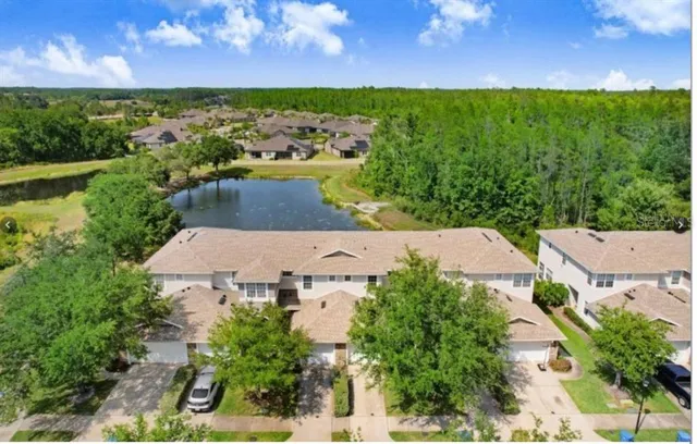 an aerial view of a house with a yard