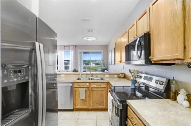 a kitchen with a sink a stove and refrigerator