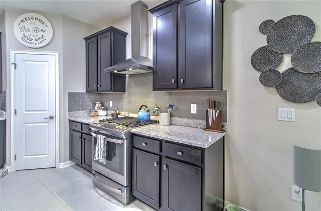 a kitchen with a stove and a refrigerator