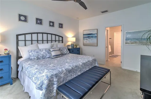 a bedroom with a bed and painting on the wall