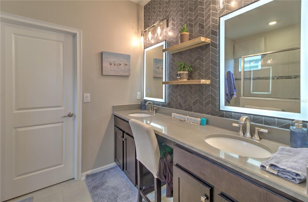 19744 Fort King Run Brooksville, FL 34601 - Photo 22 of 44 a bathroom with a granite countertop sink a mirror and shower