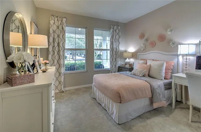 a bedroom with a large bed and a large window