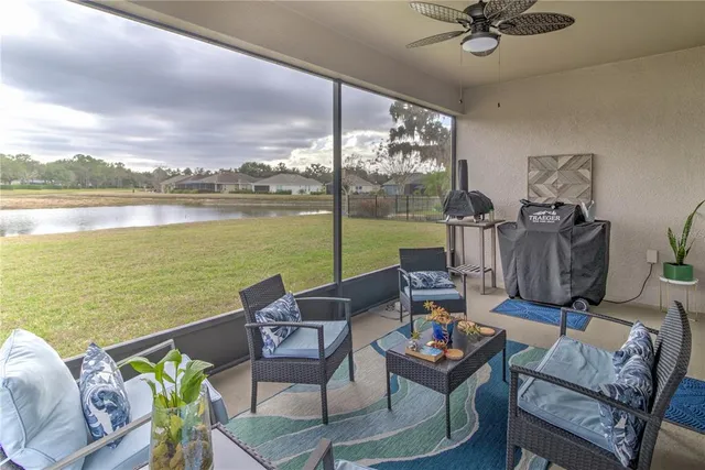 a living room with furniture and a floor to ceiling window
