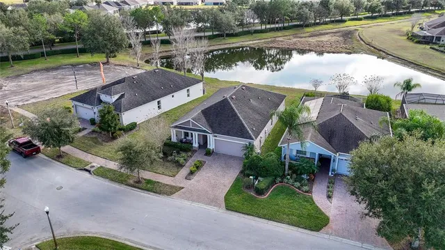 an aerial view of a house with garden space and lake view
