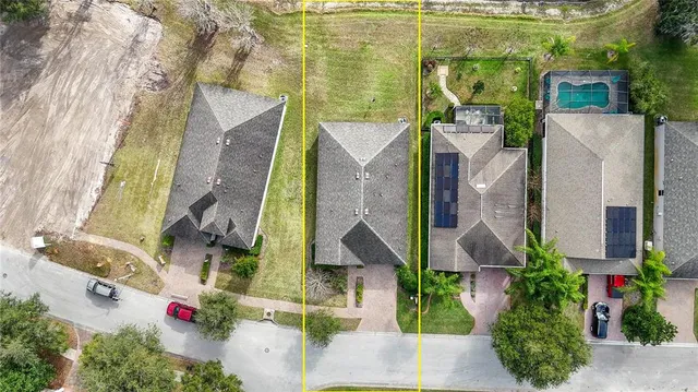 an aerial view of residential house with outdoor space and parking