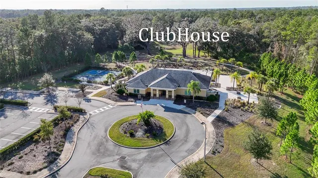 a swimming pool with outdoor seating and yard