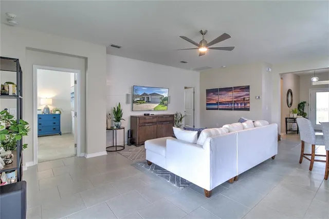 a living room with furniture and a chandelier
