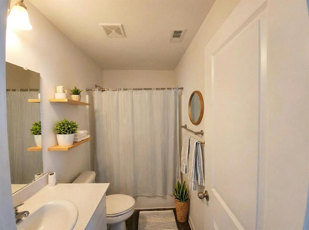 6114 Harrah Lane Forney, TX 75126 - Photo 4 of 10 a bathroom with a granite countertop bathtub shower sink vanity and toilet