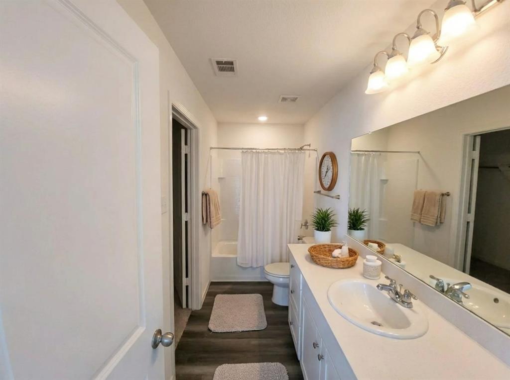 6114 Harrah Lane Forney, TX 75126 - Photo 7 of 10 a bathroom with a double vanity sink mirror and shower