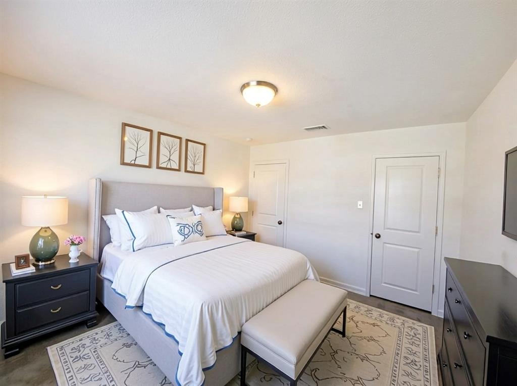 6114 Harrah Lane Forney, TX 75126 - Photo 8 of 10 a bedroom with a bed and wooden floor