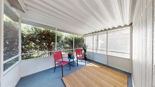 a balcony with chairs and a table