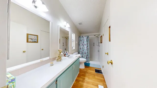 a spacious bathroom with a double vanity sink and a mirror