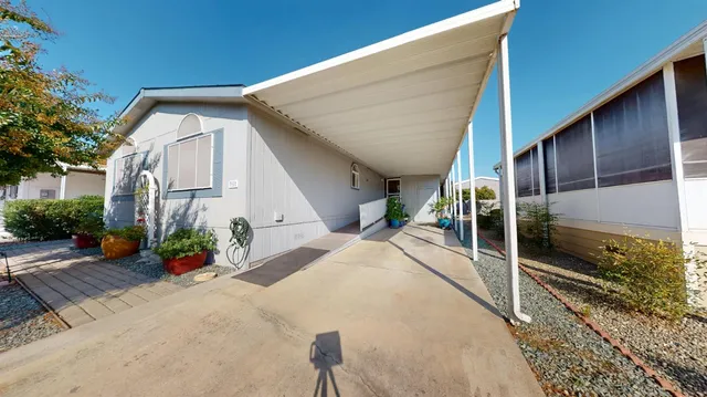 a view of a patio with table and chairs