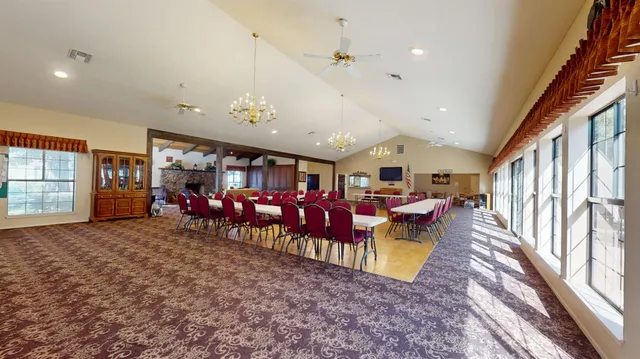 a living room with furniture fireplace and a large window