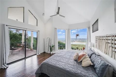 a bedroom with furniture and a large window