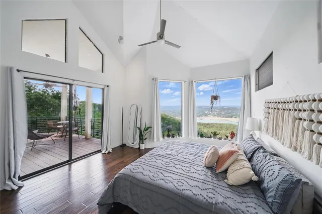 a bedroom with furniture and a large window