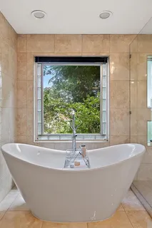 a white bath tub sitting in a bathroom