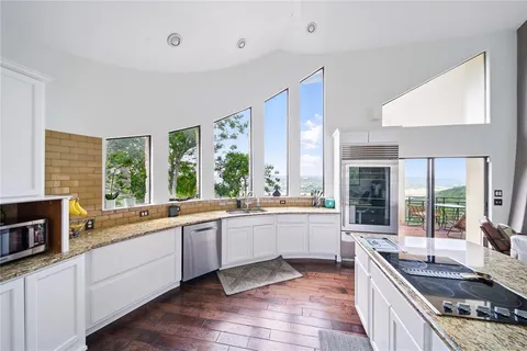 a large kitchen with a stove top oven