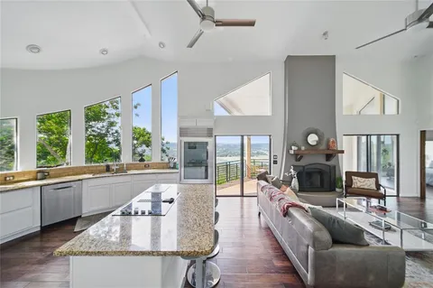 a kitchen with granite countertop attached living room