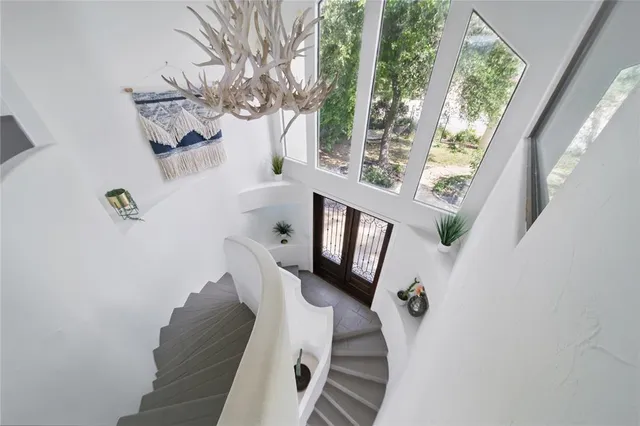 a vase of flowers sitting on a table in front of a window