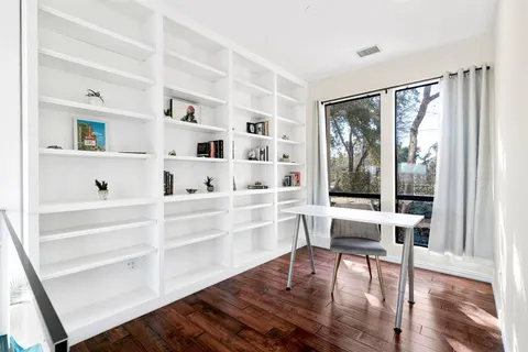 a spacious bathroom with a granite countertop sink and a bathtub