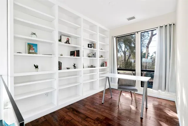a spacious bathroom with a granite countertop sink and a bathtub