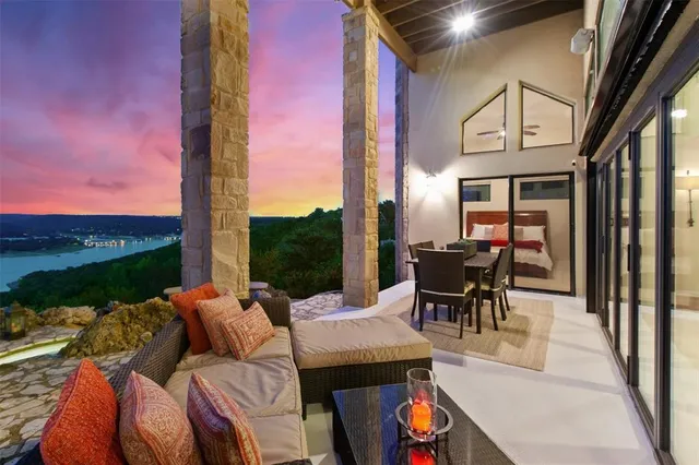 a living room with furniture and floor to ceiling windows
