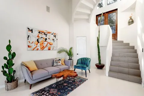 a living room with furniture and flowers