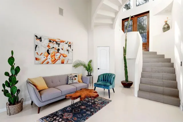 a living room with furniture and flowers