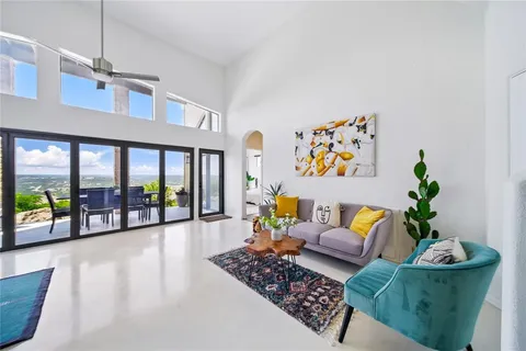 a living room with furniture and a floor to ceiling window