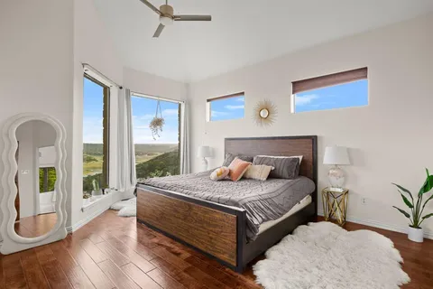 a bedroom with a bed and a large window