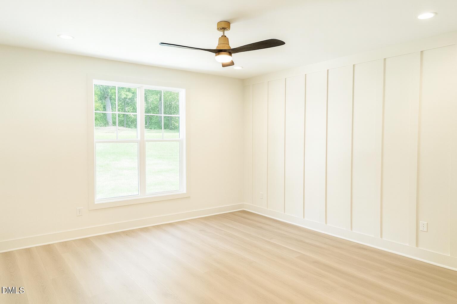 3345 Fleming Graham Road Burlington, NC 27217 - Photo 5 of 12 an empty room with a window and a ceiling fan