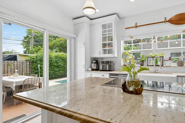 a kitchen with a stove a faucet a cabinets and furniture