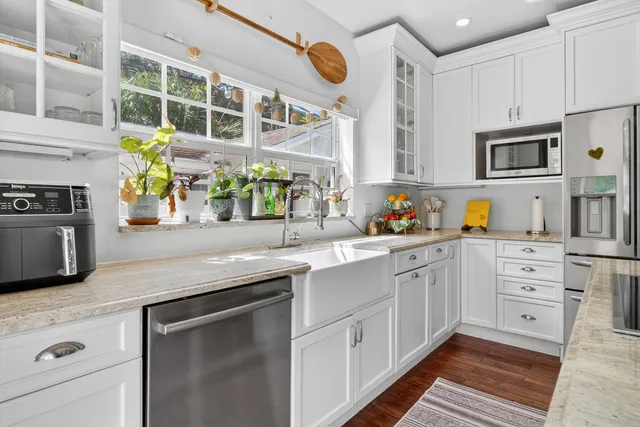 a kitchen with stainless steel appliances granite countertop a sink and cabinets