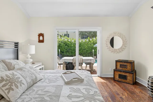 a bedroom with a bed a couch and a floor to ceiling window