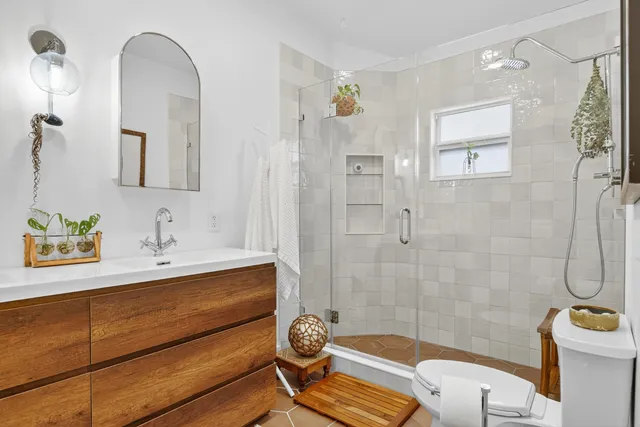 a bathroom with a sink toilet and shower