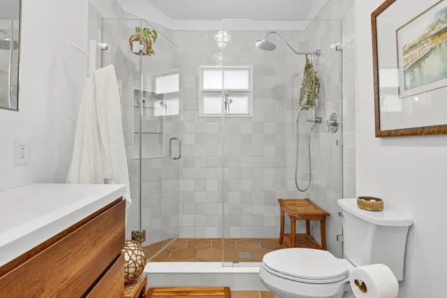 a bathroom with a sink toilet and shower