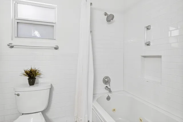 a bathroom with a toilet and a bathtub