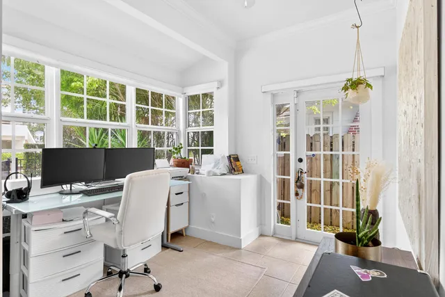 a view of a workspace with furniture and a window