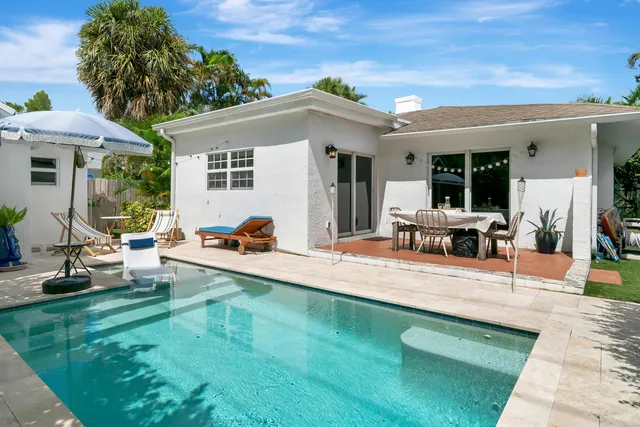 a view of a house with backyard porch and sitting area