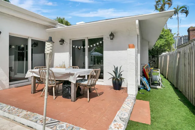 a view of a patio with table and chairs