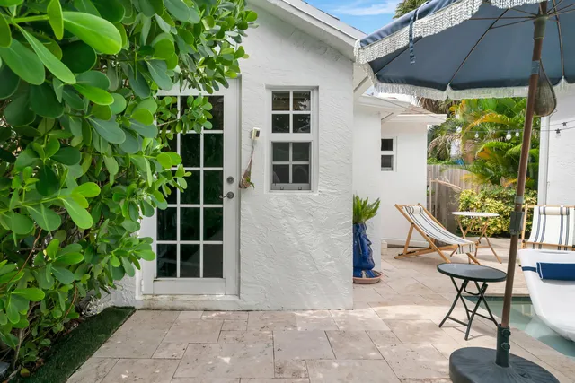 a backyard of a house with outdoor seating