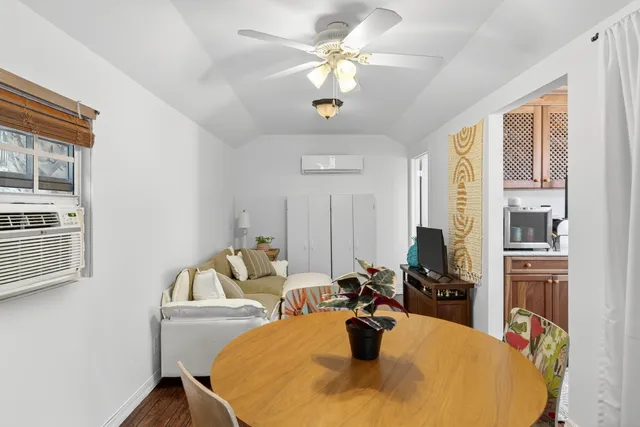 a view of a dining room with furniture and a chandelier fan