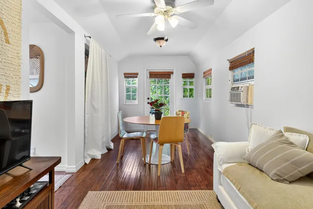 a living room with furniture dining table and a window