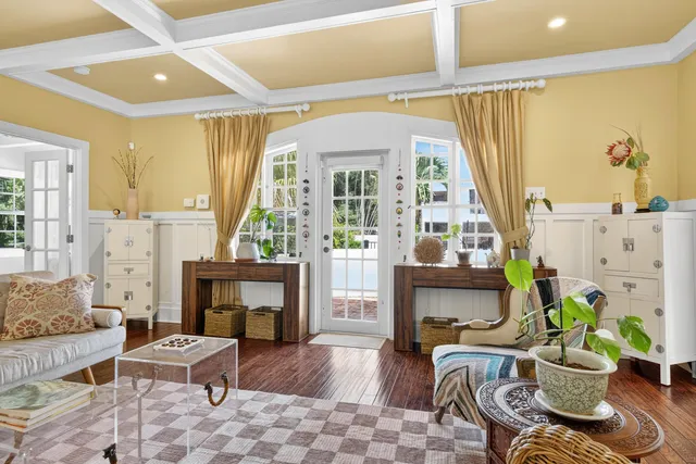 a living room with furniture a fireplace and a table