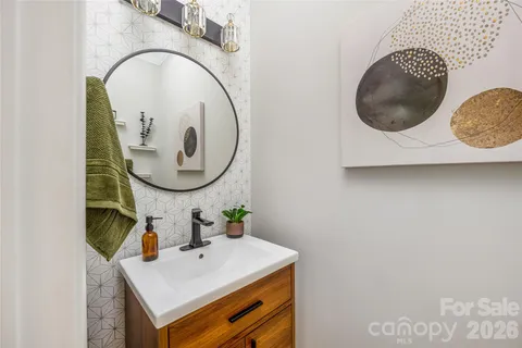 a bathroom with a granite countertop sink and shower