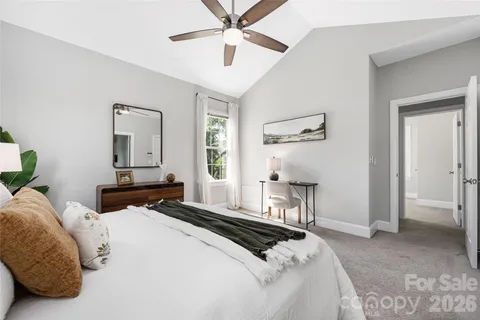 a bedroom with a bed a window and potted plant