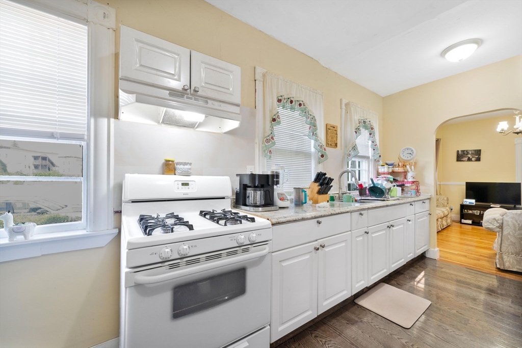 96 Garfield Street Springfield, MA 01108 - Photo 21 of 37 a kitchen with white cabinets and appliances