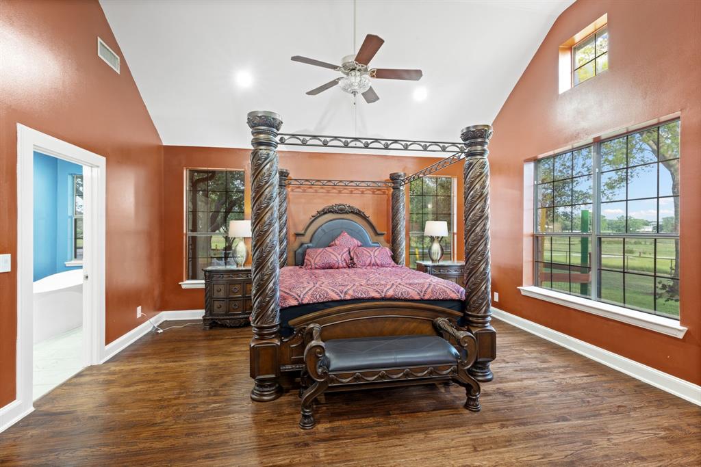 708 Sam Davis Road Argyle, TX 76226 - Photo 15 of 36 a bedroom with a bed a window and a chandelier